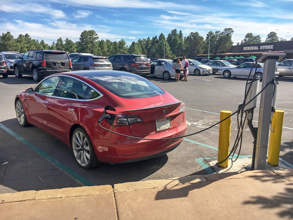An electric car charging from a home wall-box EV charger